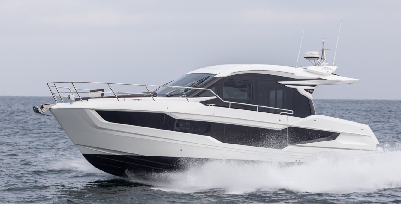 The port side of the Galeon 410 HTC yacht speeding on the open water