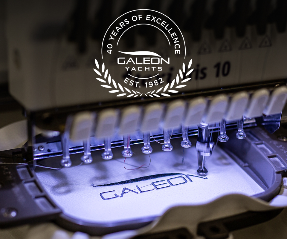 Galeon logo being sewed to the fabric on the sewing machine Galeon logo being sewed to the fabric on the sewing machine