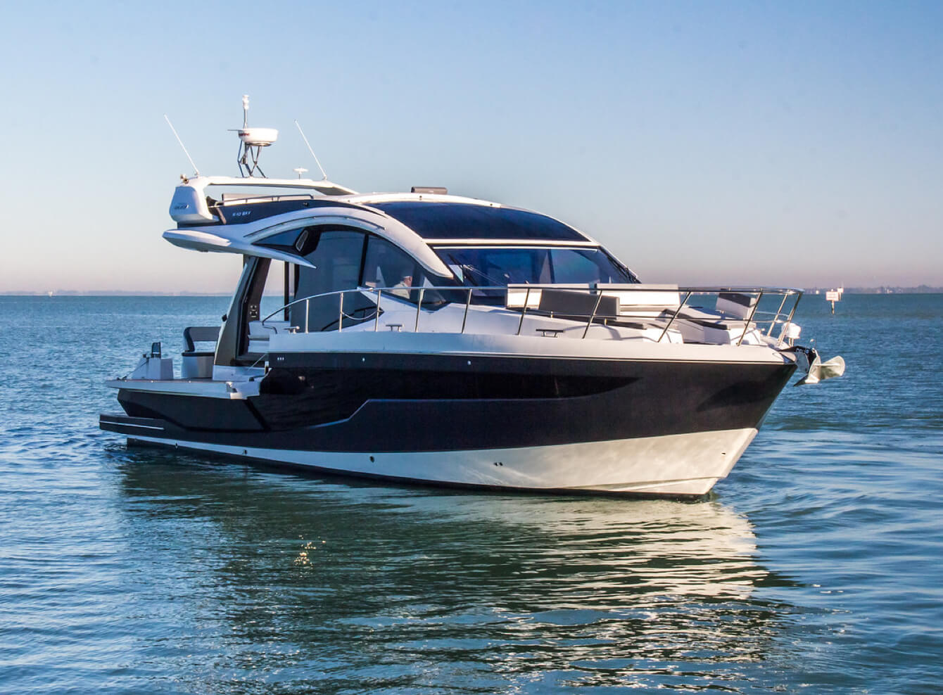 Galeon yacht at a standstill on the water with the anchor at the bow