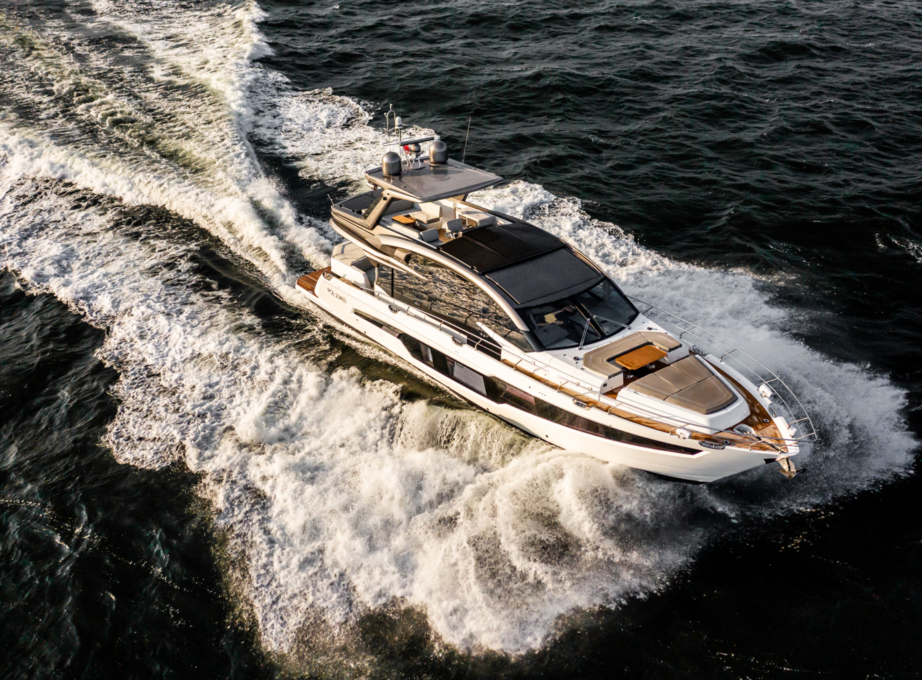 Galeon yacht speeding on the water with white foam on either side