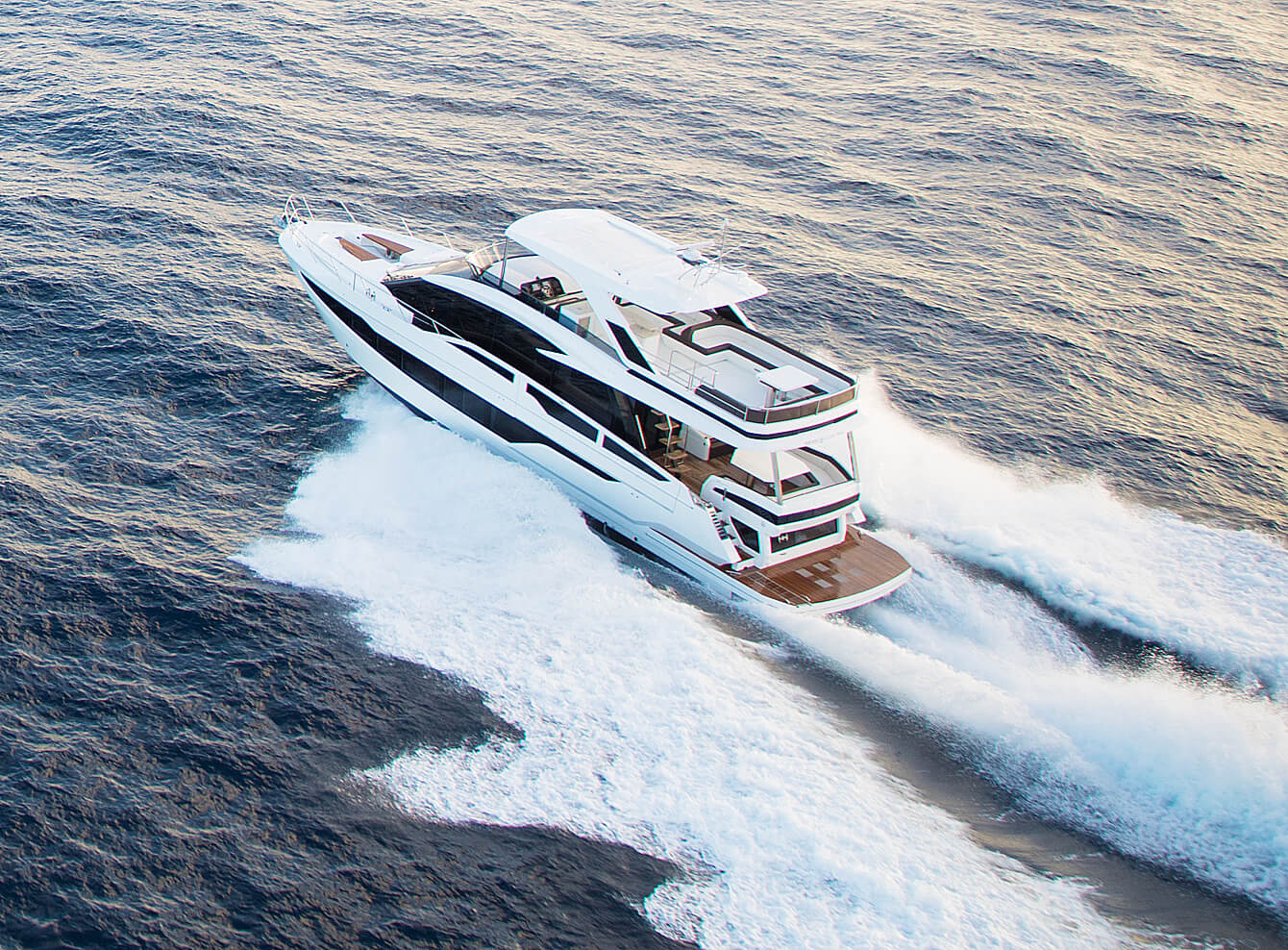 Galeon yacht cruising on open water with its wake behind it