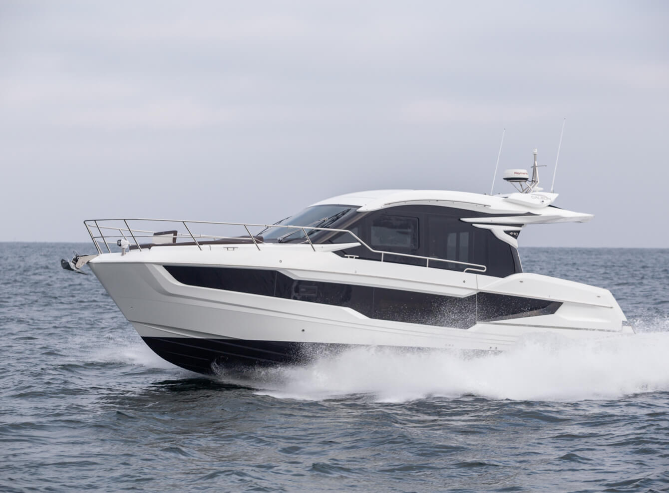 Galeon yacht cruising with water spraying up on the sides