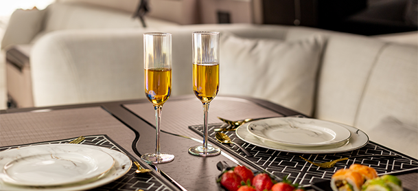 two glasses of champagne on a dinner table