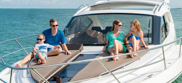 Family hanging out on the bow of a boat