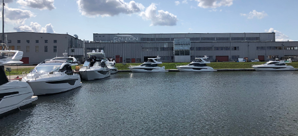 Galeon Yachts Factory with few Galeon Yachts on the water in front of it  Galeon Yachts Factory with few Galeon Yachts on the water in front of it