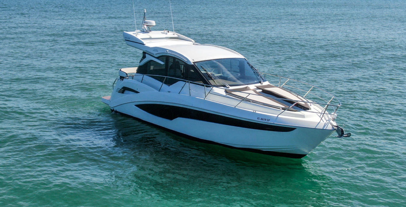 Galeon yacht at a standstill on the blueish-green water on a sunny day 