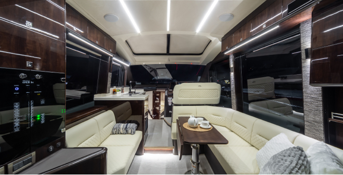 Interior seating area on a Galeon yacht with white benches and dark wood finishes on the wall