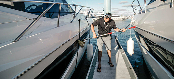 guy cleaning an outside of Galeon yacht