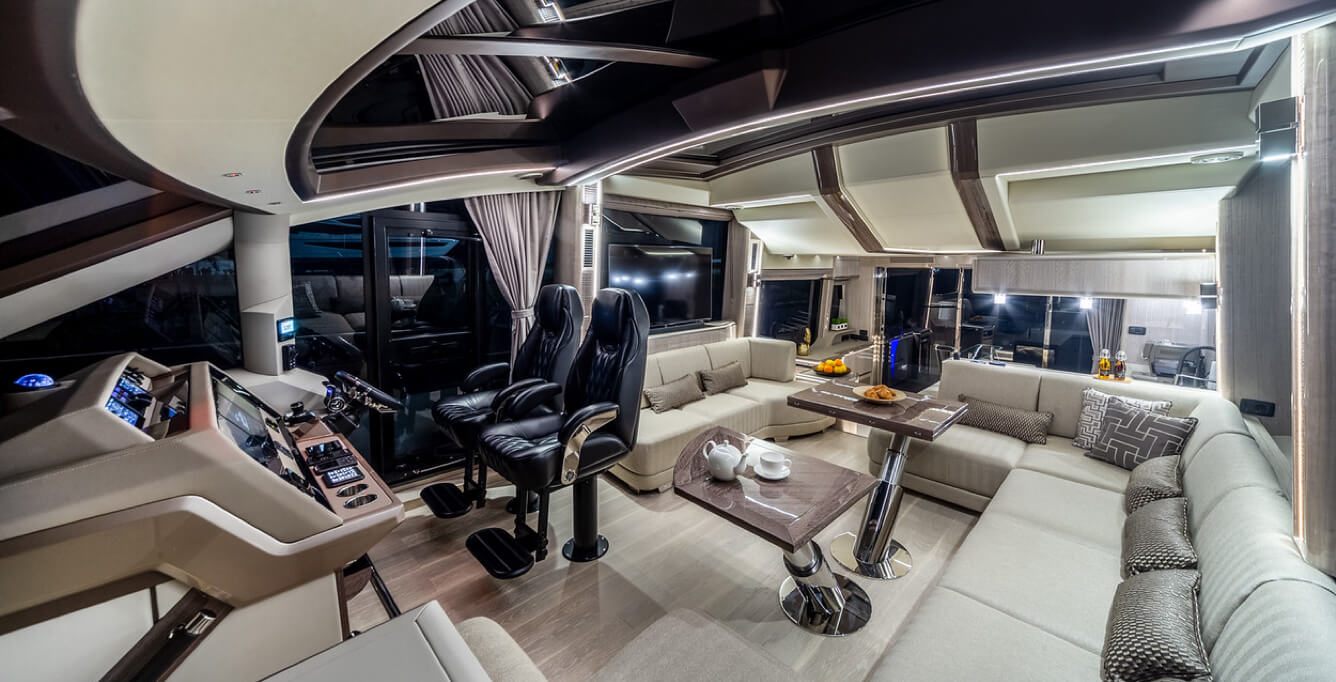 The interior seating area and driver's seat inside of a Galeon yacht 
