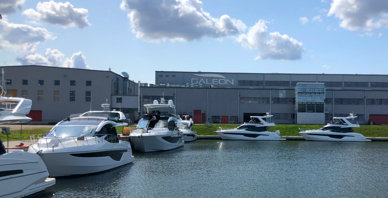 Six Galeon yachts in the water in front of the Galeon factory