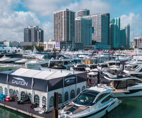 Galeon tent and yachts in a marina in front of the skyscrapers of Miami