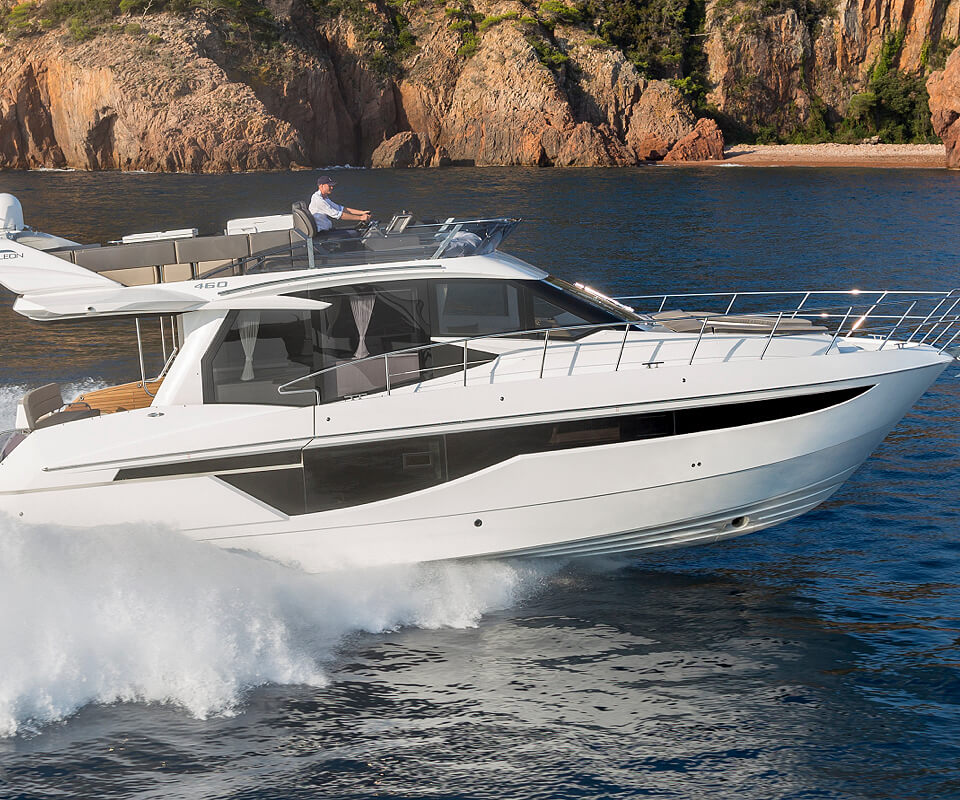 The Galeon 460 FLY yacht speeding by rocky cliffs
