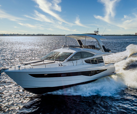 Galeon yacht cruising on the water on a cloudy day with the sun hitting the water