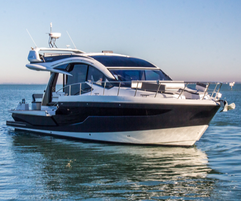 Galeon yacht at a standstill on the water with an anchor at the tip of the bow